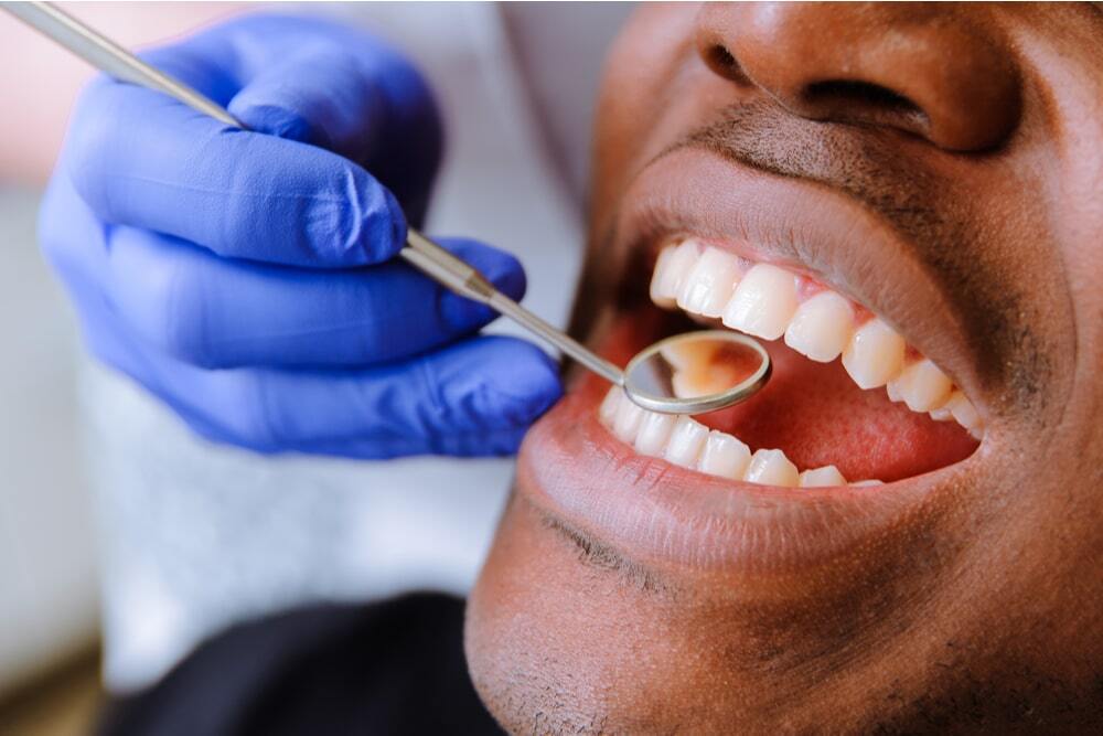 Male patient getting dental treatment in dental clinic